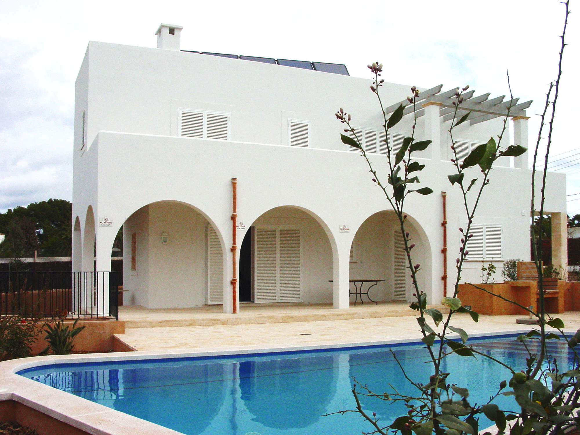 Garden front with arcades and pool